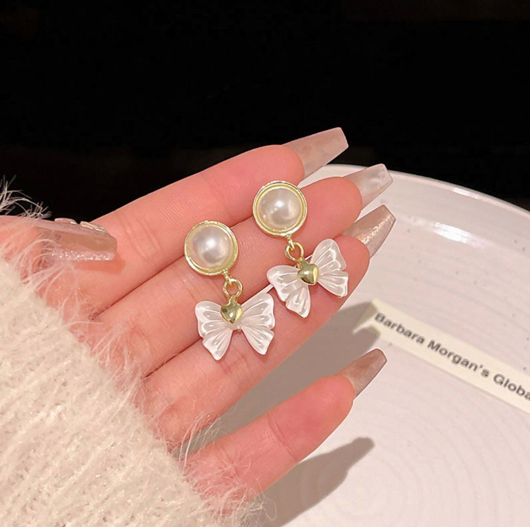 White bow pearl drop earrings